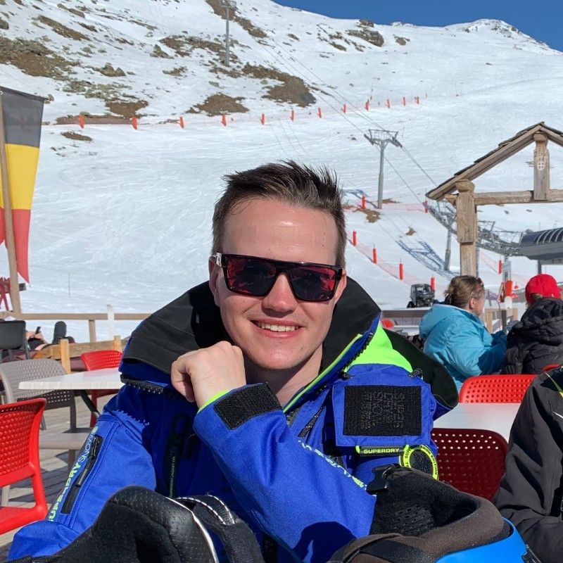 Tom on a ski holiday, smiling for the camera